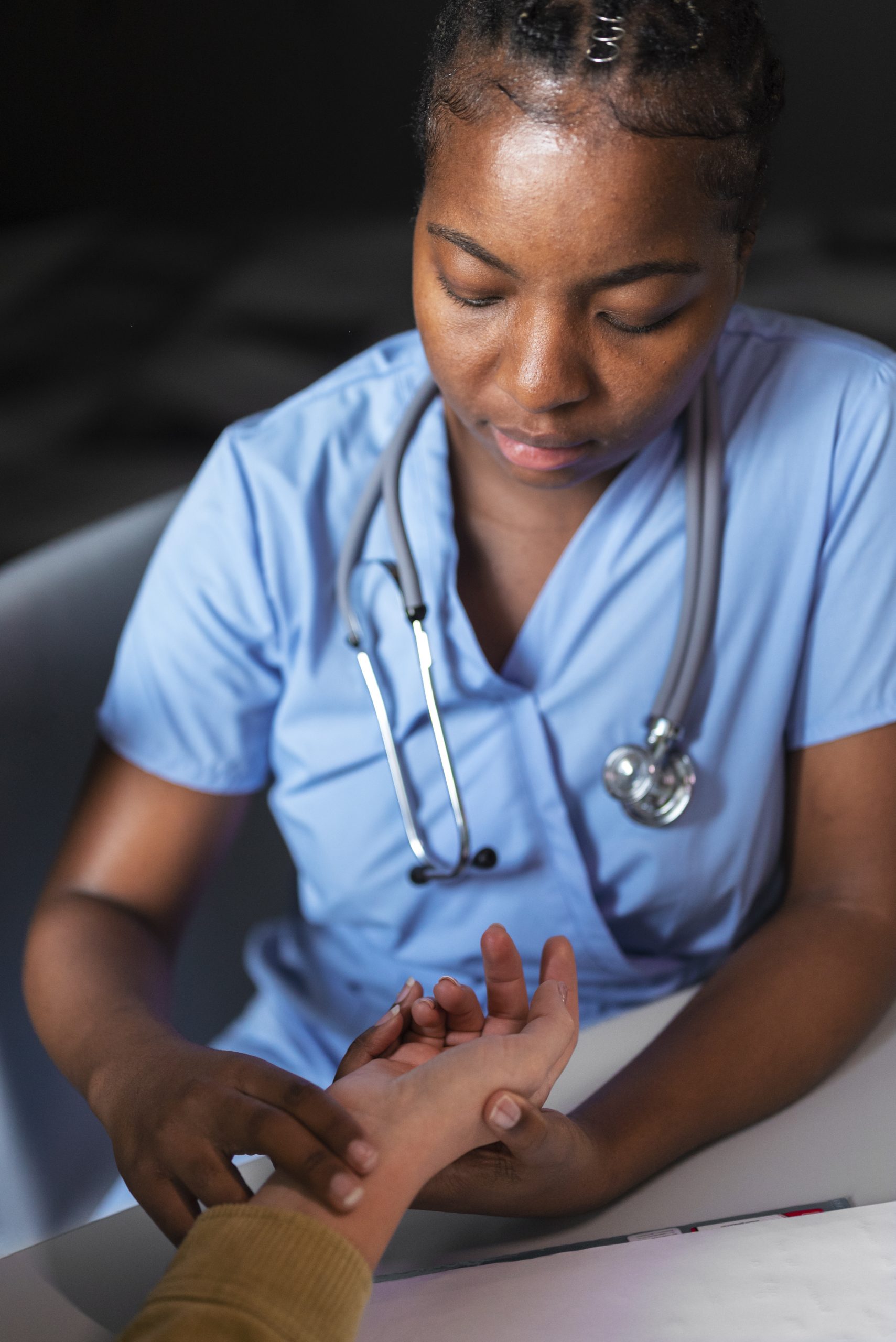 nurse feeling pulse high angle